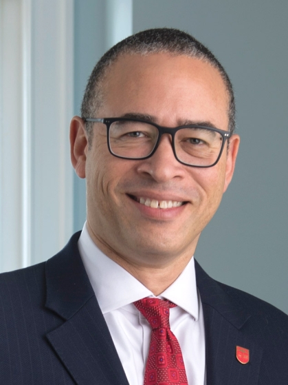 President Holloway, glasses, red tie, rutgers shield pin, navy blazer