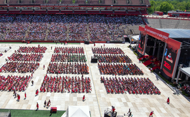 Aerial view of the graduates sitting in rows across the stage.