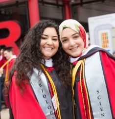 Two students pose for a photo